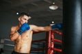 Male boxer hitting punching bag at a boxing studio