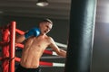 Male boxer hitting punching bag at a boxing studio