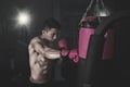 Male boxer hitting a punching bag at gym Royalty Free Stock Photo