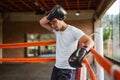 a male boxer sweaping his sweat using the black boxing gloves Royalty Free Stock Photo