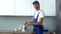 Male builder checking kitchen efficiency filling in report, smart house concept Royalty Free Stock Photo