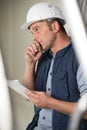 male builder with clipboard in deep contemplation Royalty Free Stock Photo