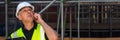 Male Builder Construction Worker on Building Site Using Phone Banner