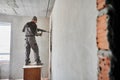 Male builder drilling wall with hammer drill in apartment. Royalty Free Stock Photo