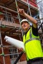 Male Builder Foreman Architect on Building Site Pointing With Plans