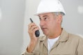 Male builder in hardhat with walkie talkie Royalty Free Stock Photo