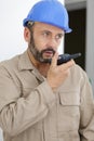 male builder in hardhat with walkie talkie Royalty Free Stock Photo