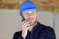 Male builder in hardhat with walkie talkie indoors Royalty Free Stock Photo