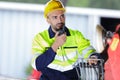 male builder in hardhat with walkie talkie outdoors Royalty Free Stock Photo