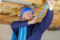 Male builder installing pipes in ceiling Royalty Free Stock Photo