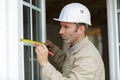 male builder measuring window Royalty Free Stock Photo