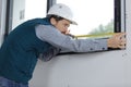 male builder measuring window Royalty Free Stock Photo