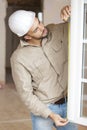 male builder measuring window Royalty Free Stock Photo