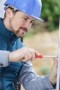 Male builder screws window stopper Royalty Free Stock Photo