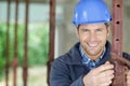 male builder setting level on acrow prop Royalty Free Stock Photo