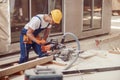 Male builder using wood cutting circular saw machine Royalty Free Stock Photo
