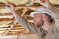male builder working on ceiling joists