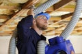 Male builder working with pipes in ceiling Royalty Free Stock Photo