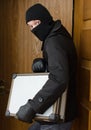 Male burglar stealing case