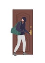 Male burglar wearing hoodie trying to unlock door with lock pick and break in house. Theft, burglary or housebreaking