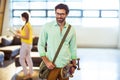 Male business executive standing with skateboard