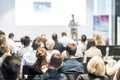 Male business speaker giving a talk at business conference event.