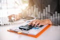 Male businessman calculates financials with graph paper. Royalty Free Stock Photo