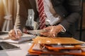 Male businessman or Designer using tablet with laptop and document on desk in modern office. Royalty Free Stock Photo