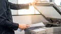 Male businessman using photocopier in office Royalty Free Stock Photo