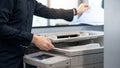 Male businessman using photocopier in office Royalty Free Stock Photo