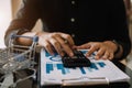 Male businessman working with holding a pen and using a calculator to calculate the numbers of static at home office. Finance Royalty Free Stock Photo