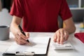 male businessman working with holding a pen and using a calculator to calculate the numbers of static at home office. Finance Royalty Free Stock Photo