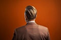 Male businessperson back portrait on orange backdrop. Generate ai