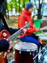 Male buskers on autumn outdoor play guitar. Royalty Free Stock Photo