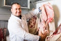 Male butcher in kosher section at supermarket