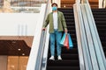 Male Buyer Shopping Posing Standing On Moving Stairs In Mall Royalty Free Stock Photo