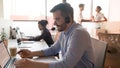 Male call center agent using computer in customer care office