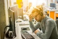 Male Call center operator wearing headset suffering from headache at office Royalty Free Stock Photo