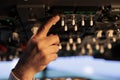 Male captain using control panel in cockpit to fly airborne aircraft Royalty Free Stock Photo