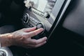 Male car driver tweaks air conditioner control close up photo Royalty Free Stock Photo