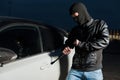 Male car thief open door with jemmy Royalty Free Stock Photo