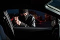 Male carjacker open car door with screwdriver Royalty Free Stock Photo