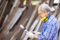 Male carpenter in a construction workshop, using a digital tablet Royalty Free Stock Photo
