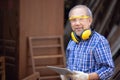 Male carpenter in a construction workshop, using a digital tablet Royalty Free Stock Photo