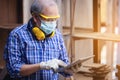 Male carpenter in a construction workshop, using a digital tablet Royalty Free Stock Photo