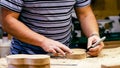 Male carpenter marking figure lines for milling on a wooden detail