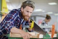 Male carpenter sawing wood Royalty Free Stock Photo