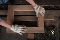 male carpenter uses sandpaper to polish the woodwork