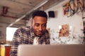 Male Carpenter In Workshop Doing Accounts On Laptop Royalty Free Stock Photo