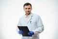 A male caucasian doctor in a white lab coat and blue disposable medical gloves Royalty Free Stock Photo